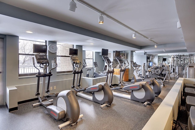 exercise room featuring track lighting