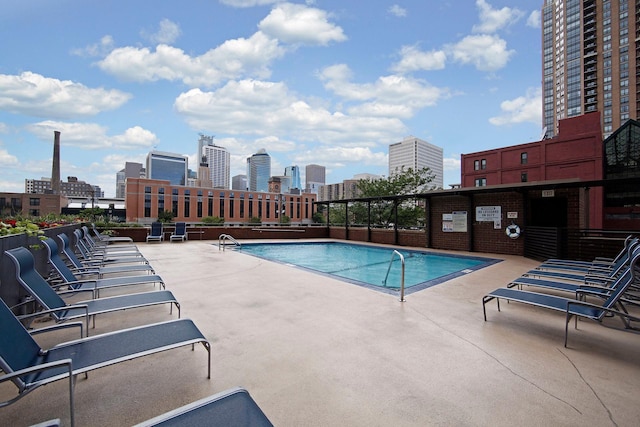 pool with a patio and a city view