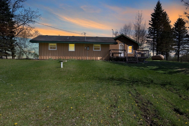 23920 Camp Dr, Daniels Twp, WI 54872 - back of house featuring a deck, board and batten siding, and a lawn