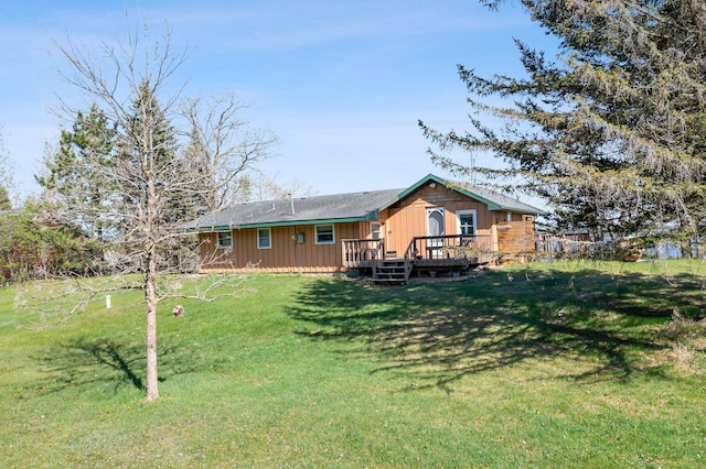 23920 Camp Dr, Daniels Twp, WI 54872 - rear view of property with a deck, a lawn, and board and batten siding