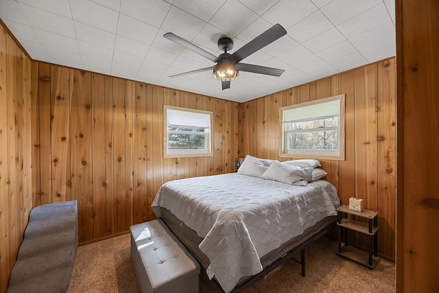 23920 Camp Dr, Daniels Twp, WI 54872 - bedroom with multiple windows, carpet, wood walls, and a ceiling fan