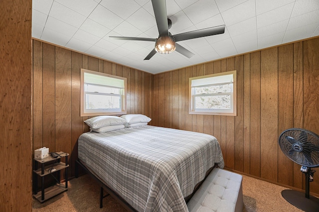 23920 Camp Dr, Daniels Twp, WI 54872 - bedroom with wooden walls, a ceiling fan, and carpet