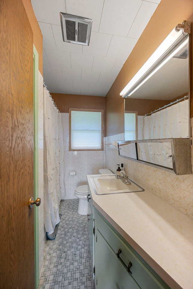 23920 Camp Dr, Daniels Twp, WI 54872 - full bathroom featuring vanity, toilet, and tile patterned floors