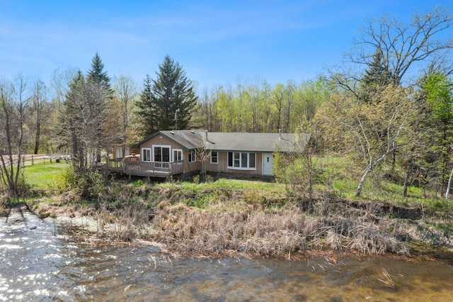 23920 Camp Dr, Daniels Twp, WI 54872 - single story home with a deck and a forest view