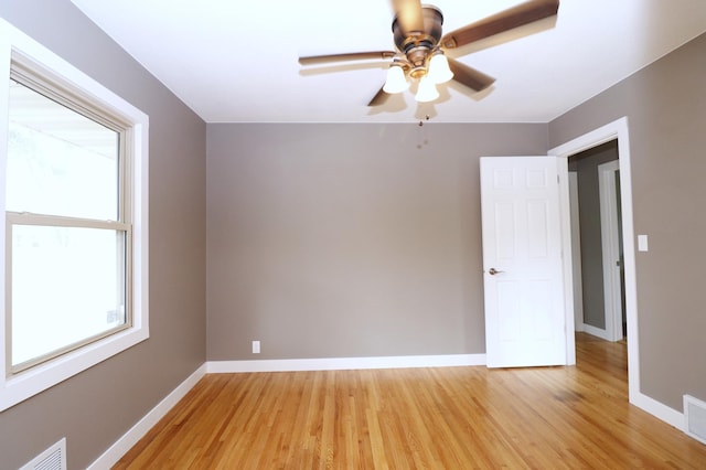10424 Washburn Ave S, Bloomington, MN 55431 - empty room with light wood-style floors, a ceiling fan, and baseboards