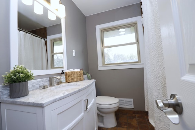 10424 Washburn Ave S, Bloomington, MN 55431 - bathroom with vanity, toilet, and stone finish flooring