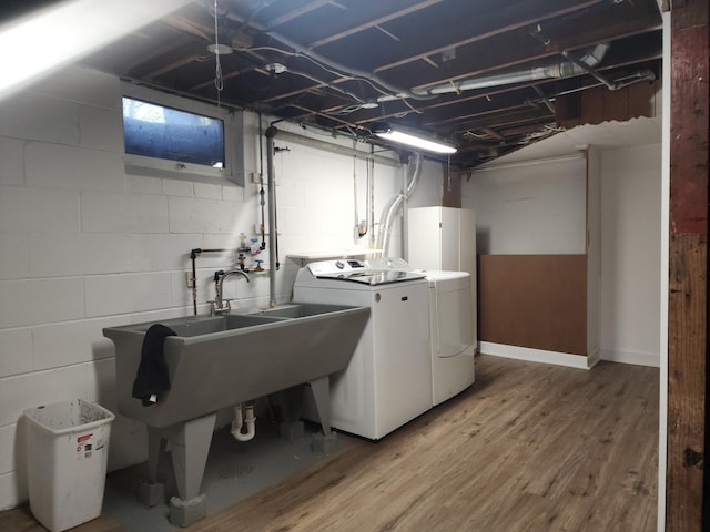 10424 Washburn Ave S, Bloomington, MN 55431 - laundry area with washer and clothes dryer, light wood-style floors, and concrete block wall