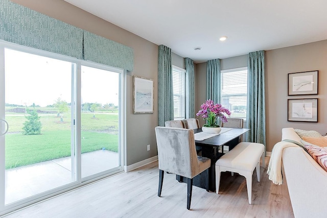dining space with baseboards, recessed lighting, and light wood-style flooring