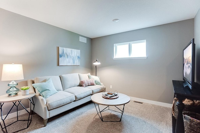 living room featuring visible vents, carpet, and baseboards