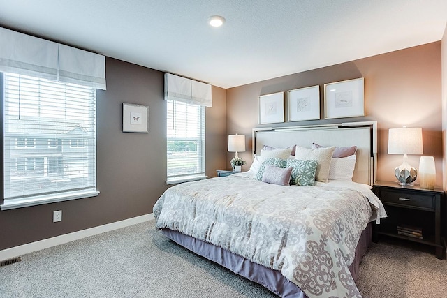 carpeted bedroom with baseboards and visible vents