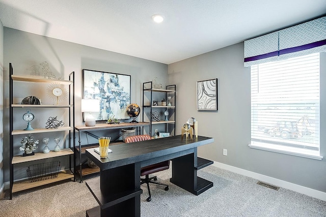 office area with visible vents, carpet, plenty of natural light, and baseboards