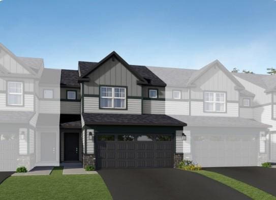 townhome / multi-family property with an attached garage, aphalt driveway, and board and batten siding