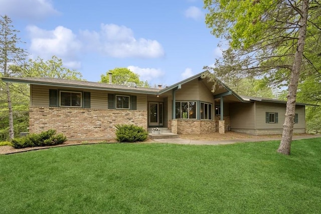 16523 243rd Ave NW, Orrock Twp, MN 55309 - rear view of property with brick siding and a lawn