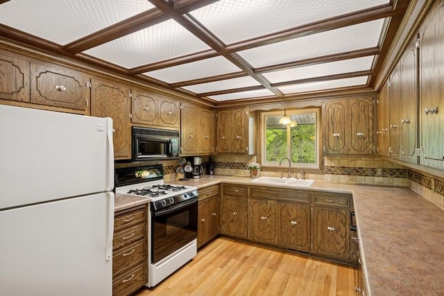 16523 243rd Ave NW, Orrock Twp, MN 55309 - kitchen with freestanding refrigerator, gas range, black microwave, a sink, and brown cabinetry