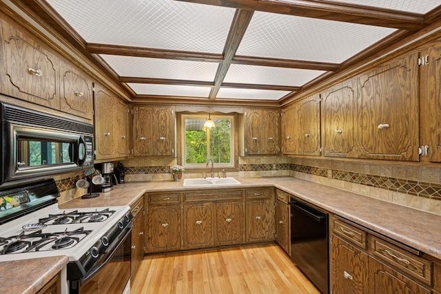 16523 243rd Ave NW, Orrock Twp, MN 55309 - kitchen with black appliances, a sink, backsplash, light wood finished floors, and brown cabinets