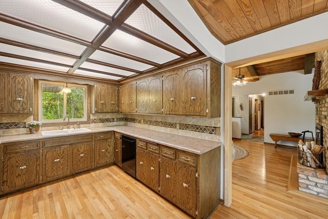16523 243rd Ave NW, Orrock Twp, MN 55309 - kitchen featuring a sink, black dishwasher, tasteful backsplash, light wood-type flooring, and beamed ceiling