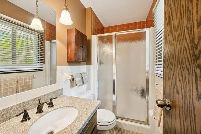 16523 243rd Ave NW, Orrock Twp, MN 55309 - full bathroom featuring vanity, toilet, a shower stall, and tile walls
