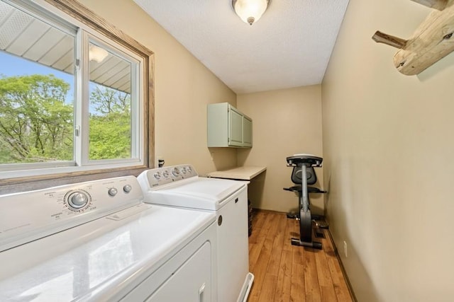 16523 243rd Ave NW, Orrock Twp, MN 55309 - washroom featuring washer and clothes dryer, cabinet space, light wood-style flooring, and baseboards