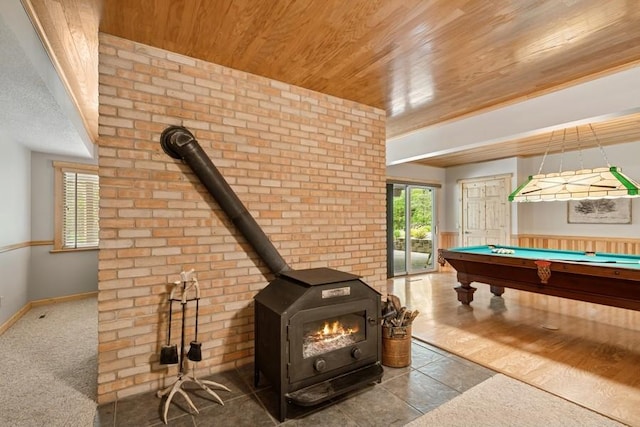 16523 243rd Ave NW, Orrock Twp, MN 55309 - game room with wooden ceiling, a wood stove, brick wall, billiards table, and baseboards