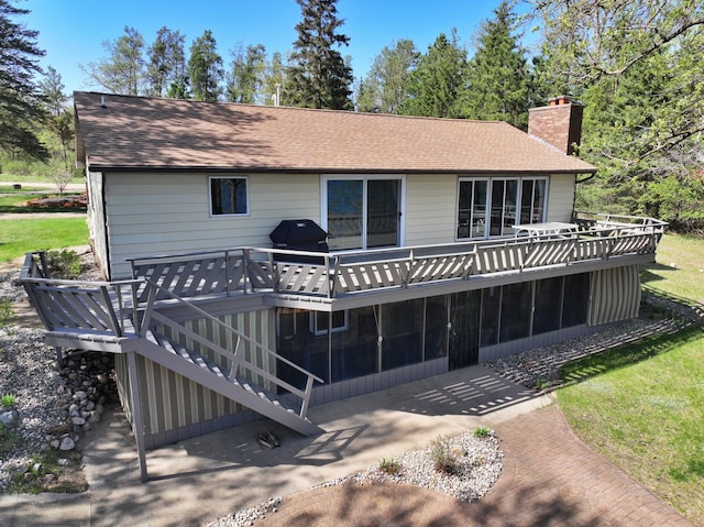 37210 Stocking Dr, Menahga, MN 56464 - back of house with a wooden deck, a chimney, a sunroom, a patio area, and roof with shingles