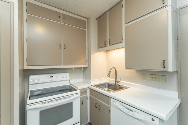 kitchen with a sink, light countertops, white appliances, and a textured ceiling