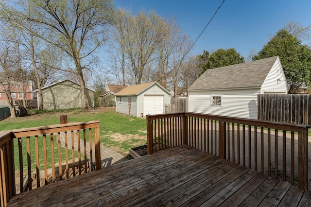 deck with fence, a residential view, a garage, an outdoor structure, and a yard