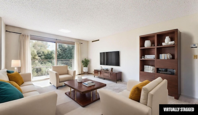 living room featuring a textured ceiling and light carpet