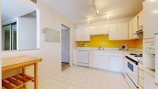 210 Grant St W Unit 204, Minneapolis, MN 55403 - kitchen with white appliances, a sink, light countertops, under cabinet range hood, and white cabinets