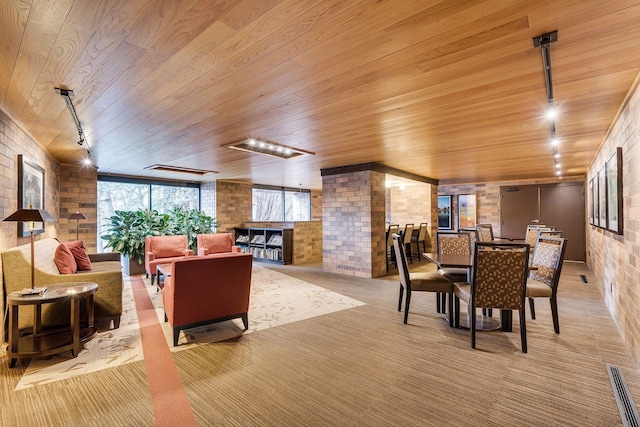 lobby featuring wood ceiling and brick wall