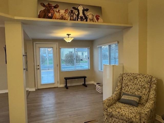 sitting room featuring baseboards and wood finished floors