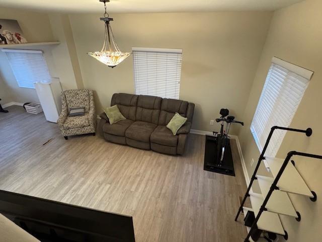 living area featuring baseboards and wood finished floors