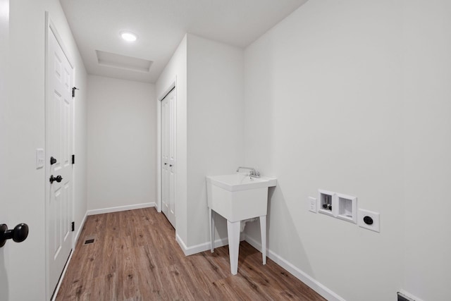 laundry room featuring washer hookup, laundry area, electric dryer hookup, wood finished floors, and baseboards