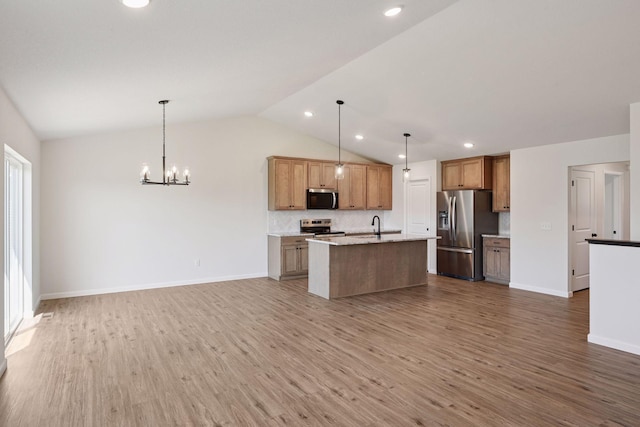 kitchen with vaulted ceiling, stainless steel appliances, light wood-type flooring, and open floor plan