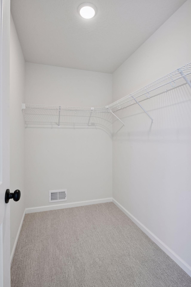 walk in closet with carpet floors and visible vents