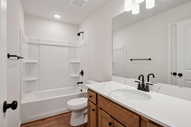 bathroom featuring vanity, toilet, bathing tub / shower combination, wood finished floors, and visible vents