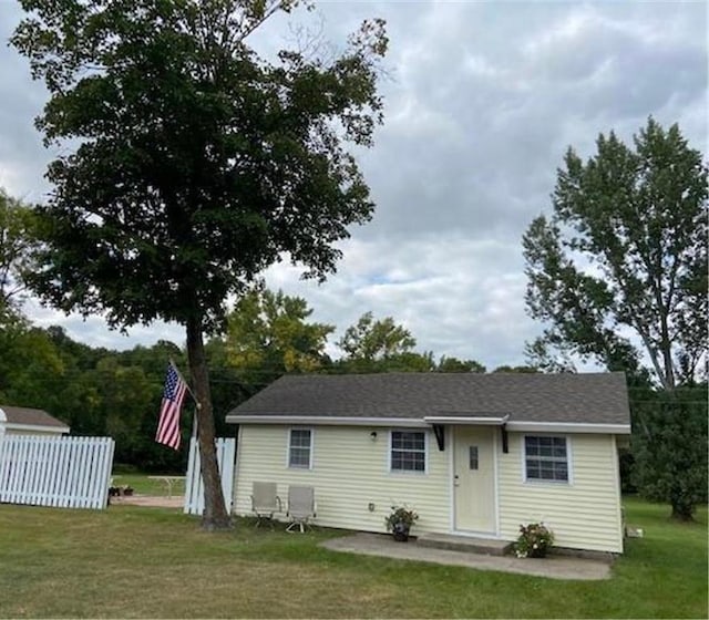 back of property with a lawn