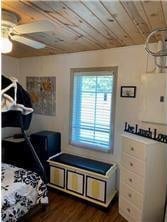 bedroom with wood ceiling and dark wood-style floors