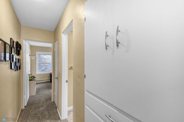 hall featuring light colored carpet, baseboards, and a baseboard heating unit