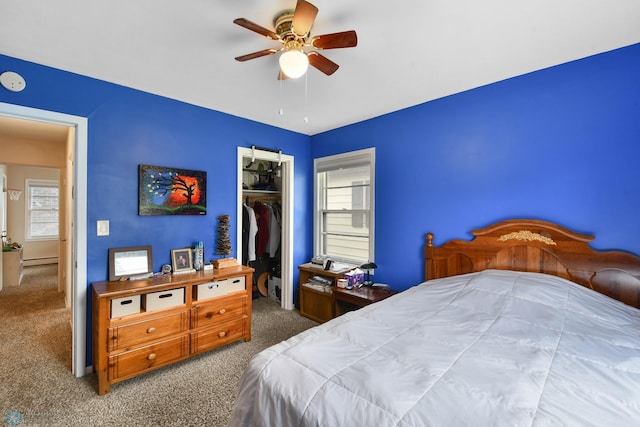 bedroom featuring carpet flooring, ceiling fan, baseboard heating, and a closet
