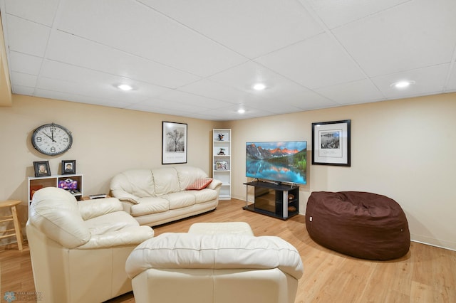living area featuring recessed lighting, baseboards, built in shelves, and wood finished floors