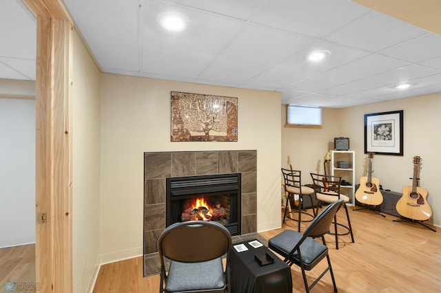 sitting room with a fireplace, recessed lighting, and wood finished floors
