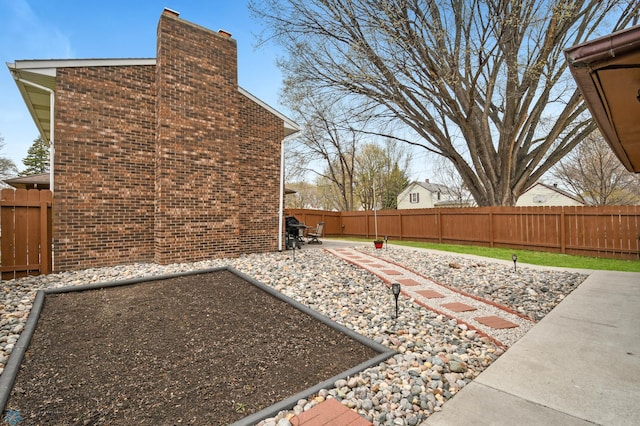 view of yard with a fenced backyard and a patio