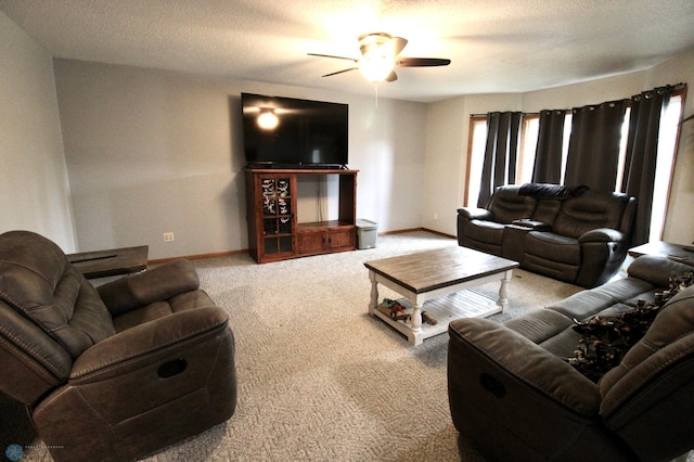 living room with baseboards, carpet flooring, a textured ceiling, and ceiling fan