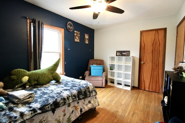 bedroom featuring a ceiling fan and light wood finished floors