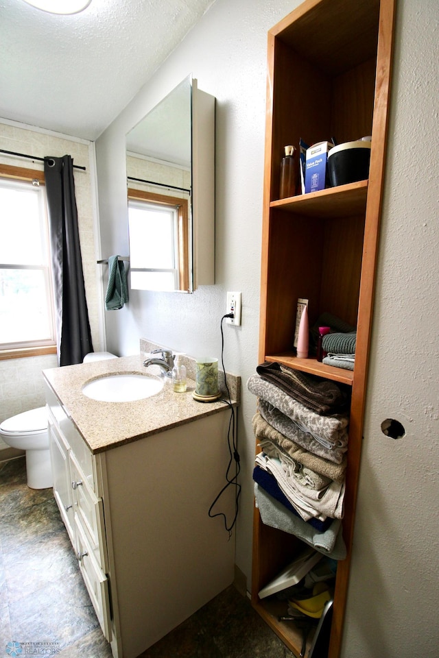 half bathroom with toilet and vanity