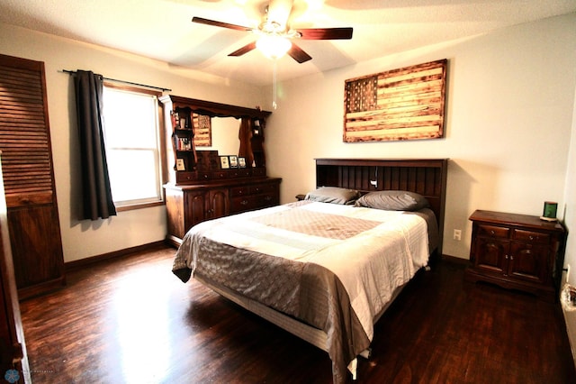 bedroom featuring baseboards, ceiling fan, and wood finished floors