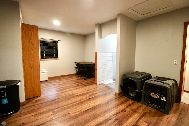 interior space featuring baseboards and wood finished floors