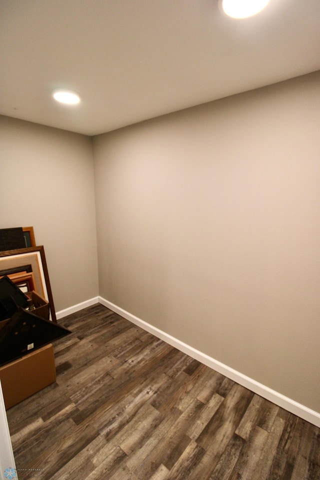 interior space with baseboards and dark wood finished floors