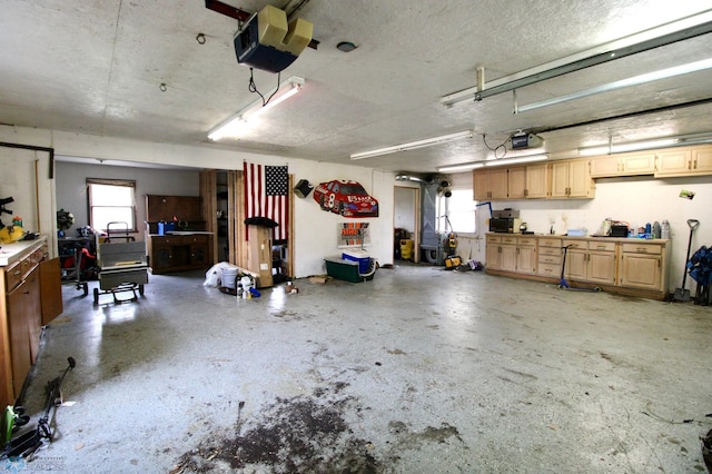garage featuring a garage door opener and a workshop area
