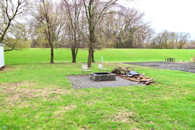 view of yard with a patio and an outdoor fire pit